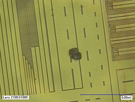Foreign particle mixed into an IC chip (1000x)